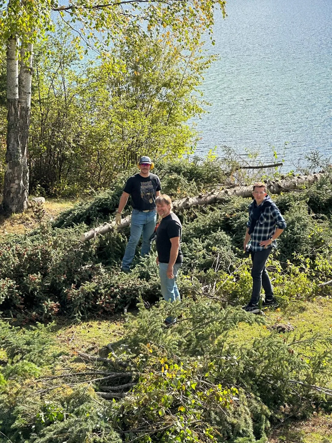 Clearing trees by the lake with family